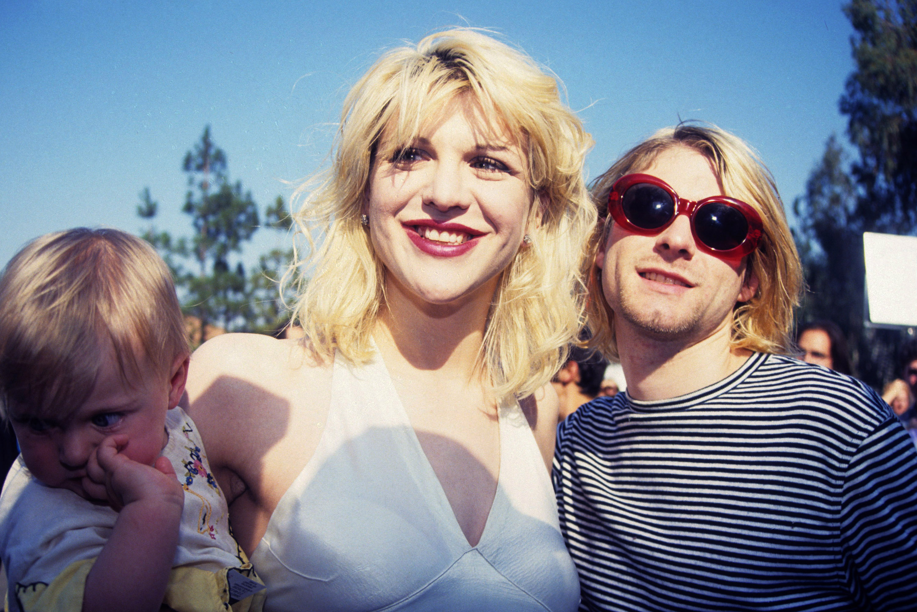 Kurt Cobain of Nirvana (right) with wife Courtney Love and daughter Frances Bean Cobain (Photo by Terry McGinnis/WireImage)